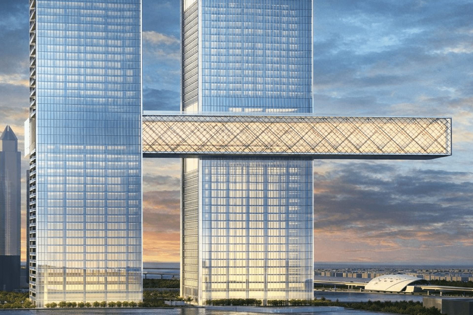 Modern glass skyscrapers with connecting crossover bridge and waterfront cityscape view.