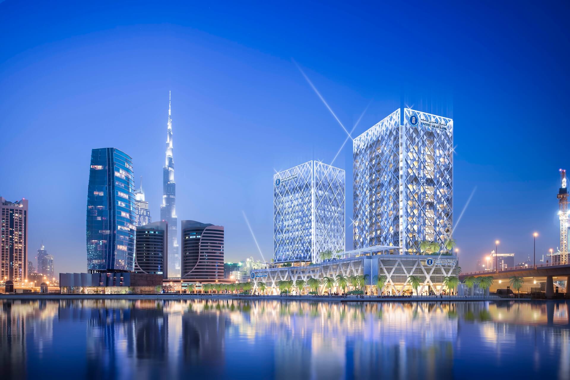 Dubai skyline at dusk with illuminated buildings reflected in waterfront canal