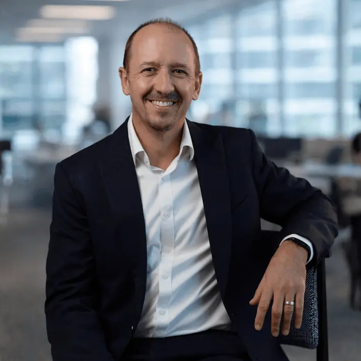 Smiling man in business suit portrait in modern office setting