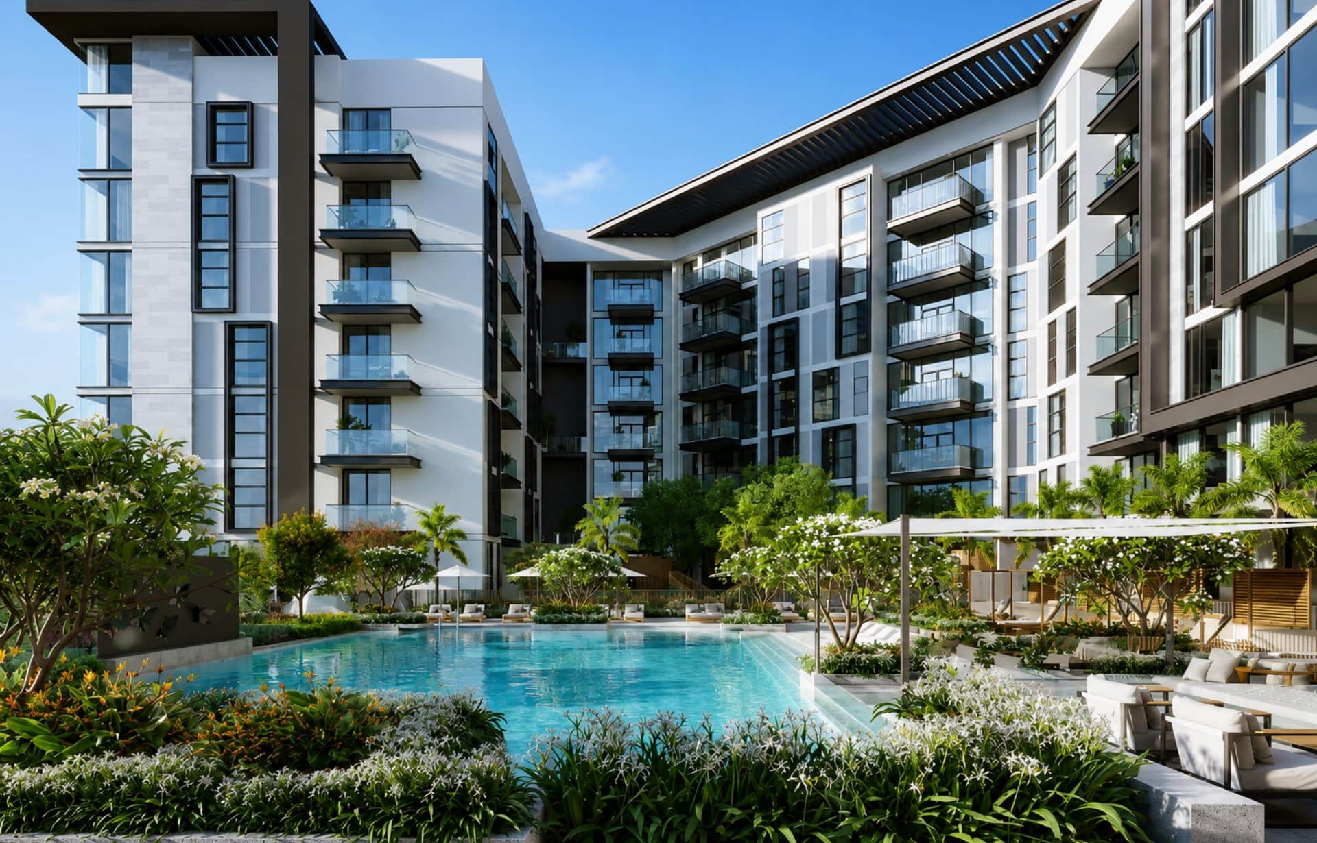 Modern apartment complex courtyard with swimming pool, tropical landscaping, and white buildings