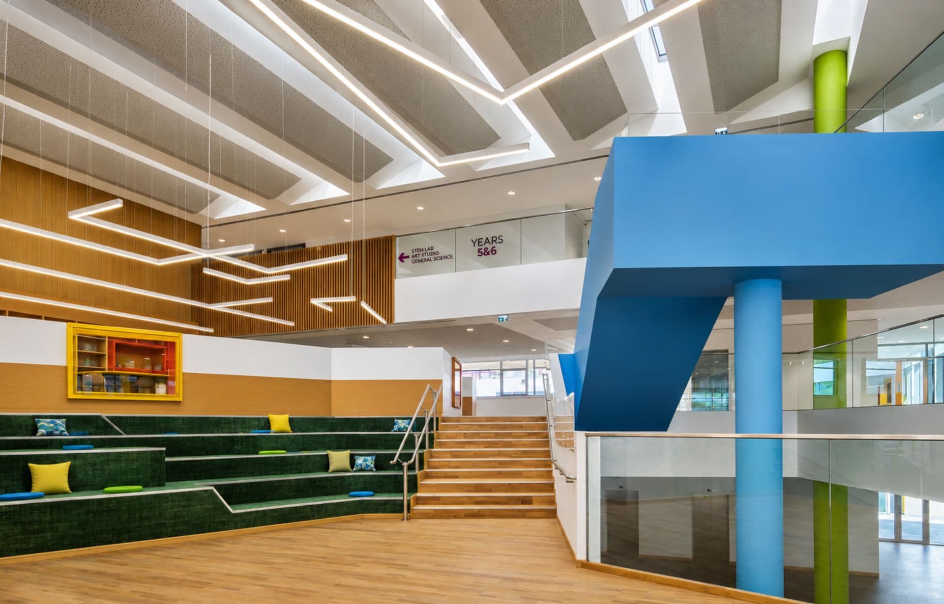 Modern school building interior with colorful architecture, geometric shapes, and multi-level spaces