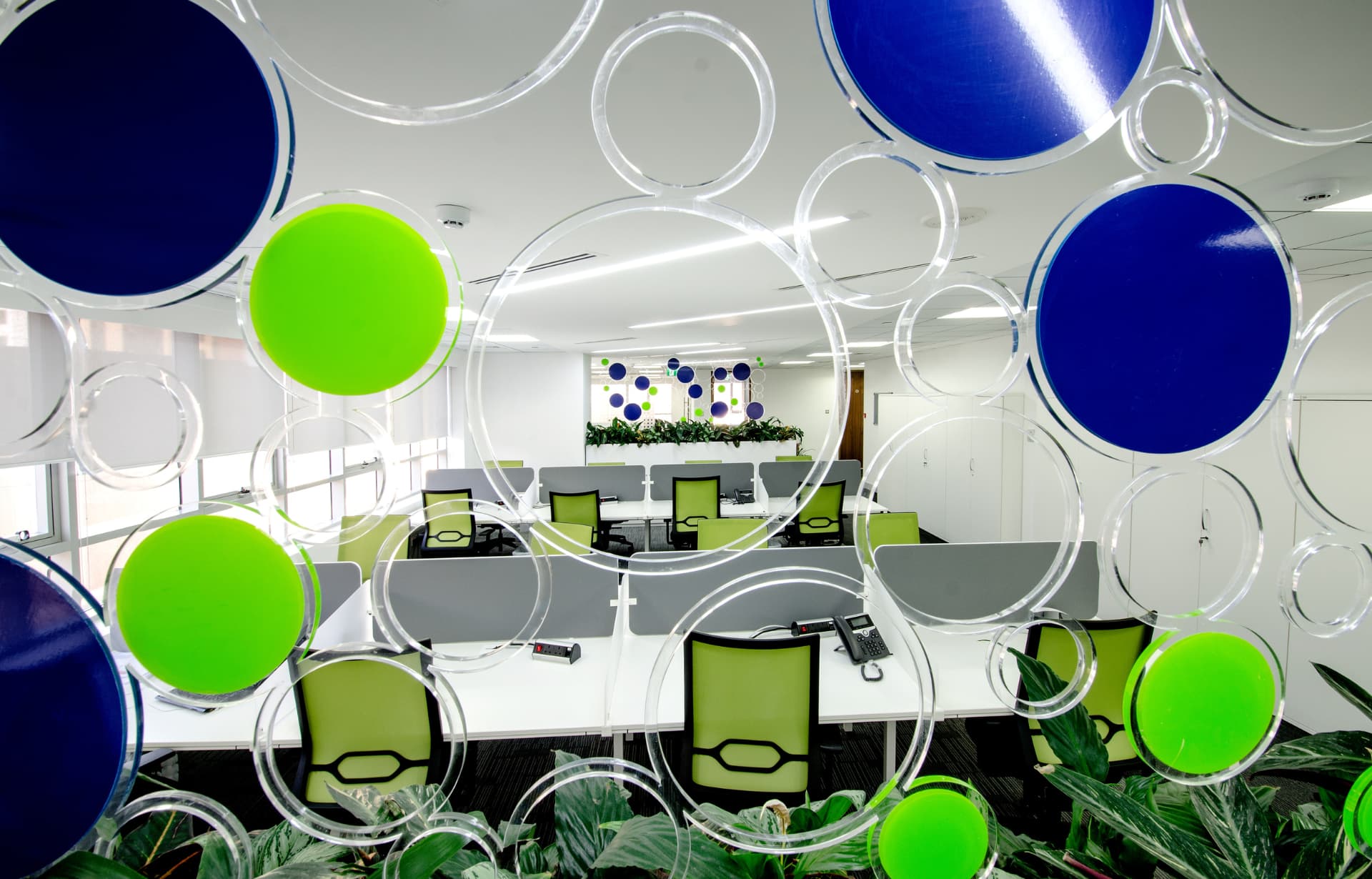 Modern office interior with colorful circular decorations in green, blue, and transparent circles.