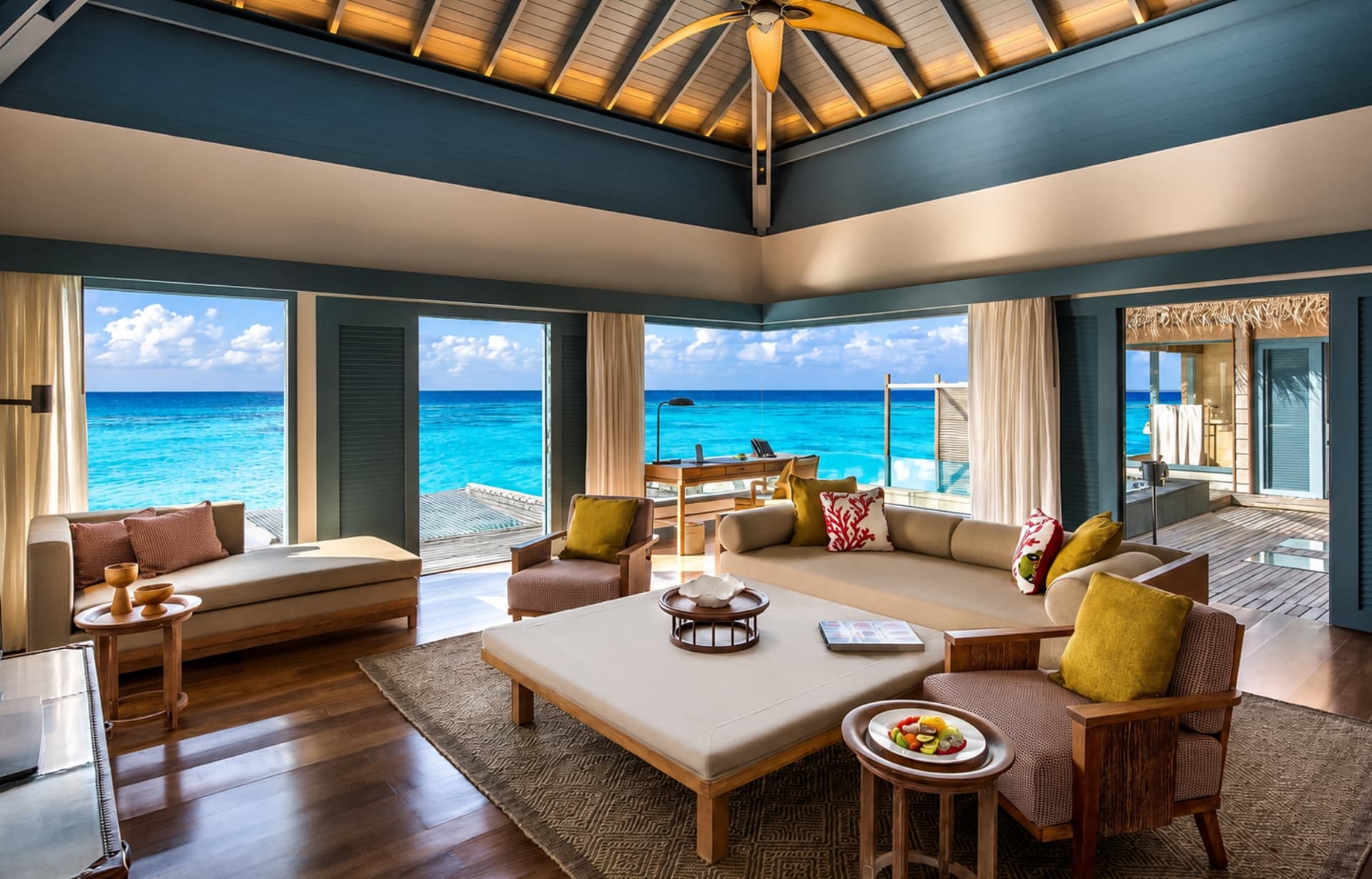Luxurious tropical beach villa living room with panoramic ocean views and modern furnishings.