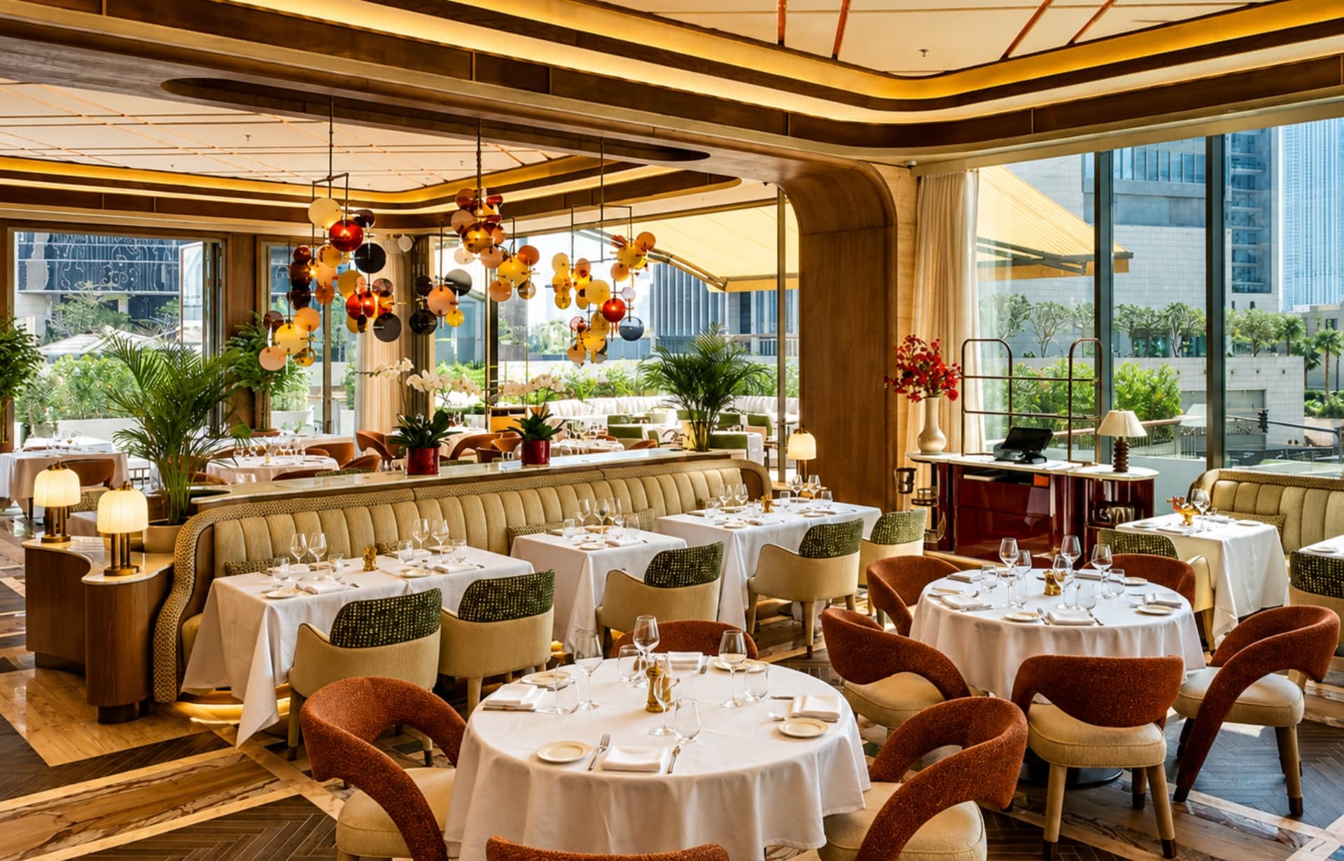 Luxury fine dining restaurant with elegant decor, hanging glass chandeliers, and city views.
