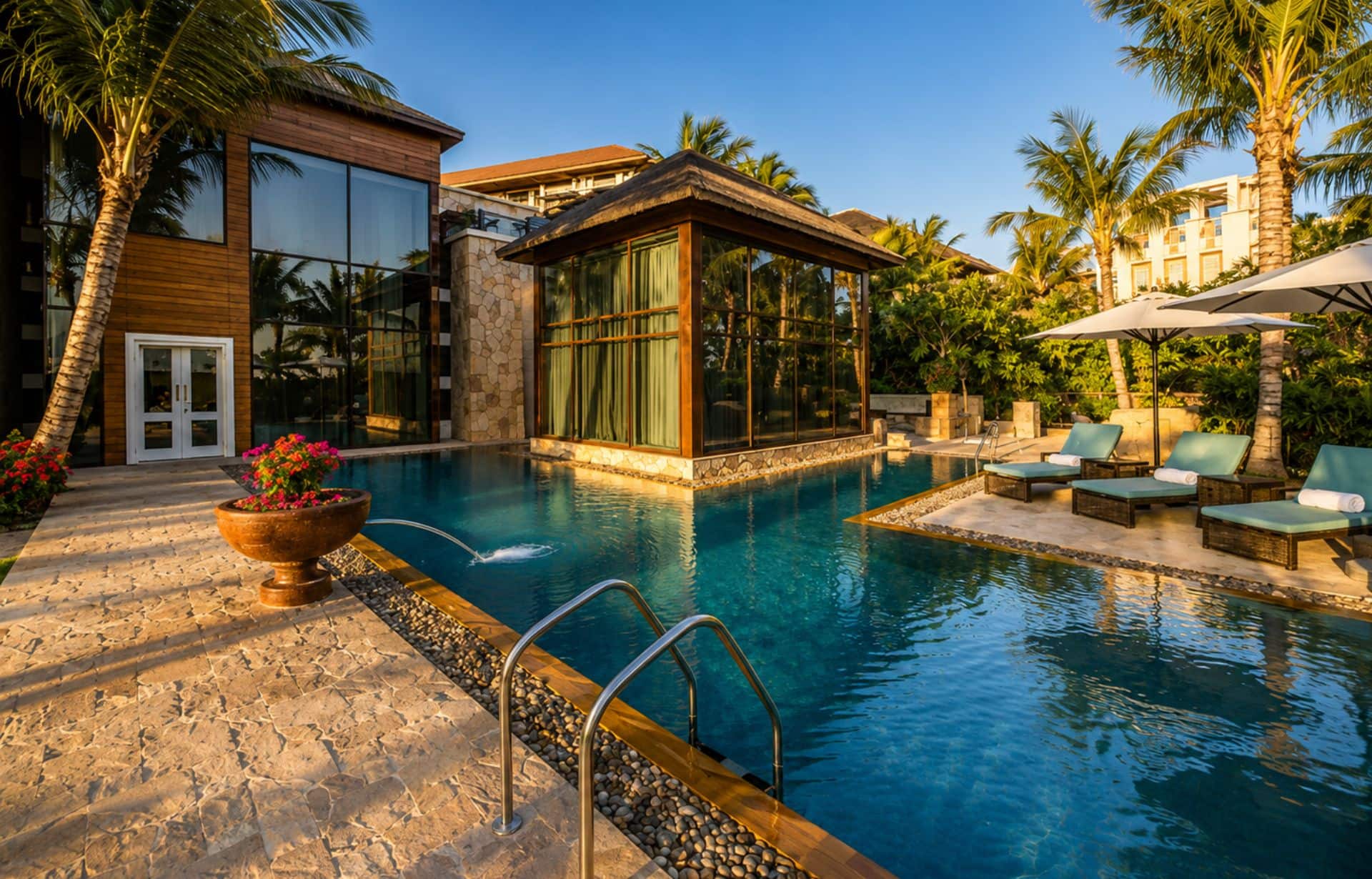 Luxury tropical resort with infinity pool, palm trees, modern architecture, and lounge chairs