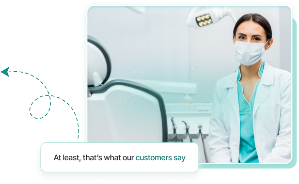 Female healthcare professional wearing a mask and white coat sitting in a medical or dental office.