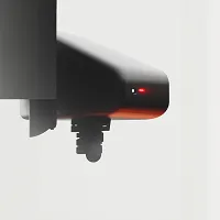 Close-up of a black modern security camera with red indicator lights against a light gray background.