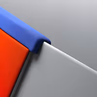 Close-up of interlocking panels in blue, red, and gray textured materials with a modern minimalist design.