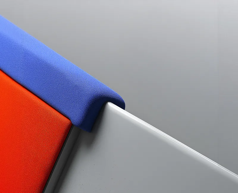 Close-up of a modern chair corner with blue and orange fabric upholstery against a gray background.