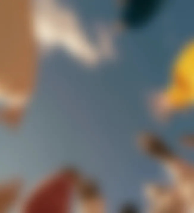 Blurred image with indistinct shapes and colors, predominantly blue background with tan, yellow, and brown areas.