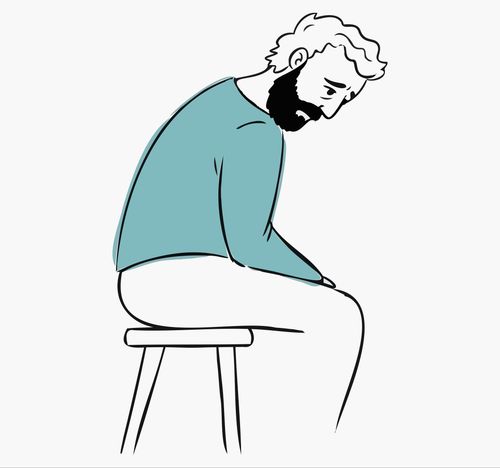 Illustration of a man with a beard and blue sweater sitting on a stool, hunched over with a sad expression.