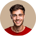 Smiling young man with short brown hair wearing a red shirt against a beige background.
