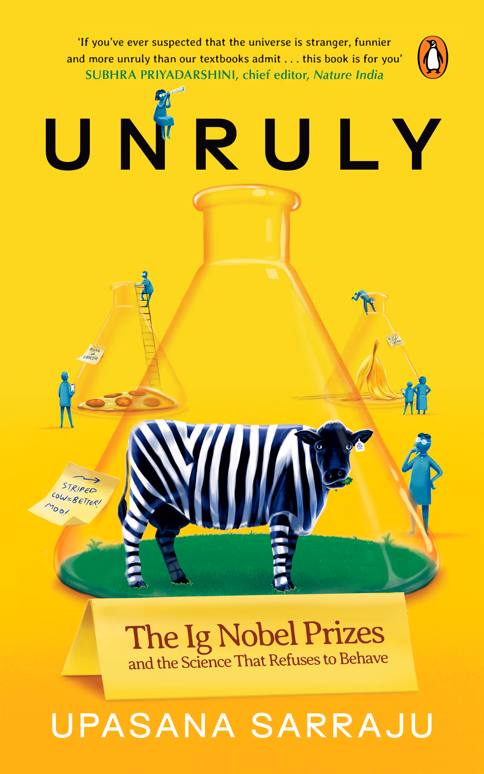 Book cover titled 'Unruly: The Ig Nobel Prizes and the Science That Refuses to Behave' by Upasana Sarraju featuring a black and white striped cow inside a large flask with smaller flasks in the background containing a pizza and a banana peel.