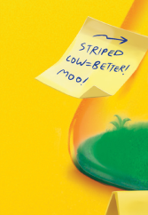 Sticky note with handwritten text saying 'STRIPED LOW=BETTER! moo!' and an arrow pointing right, placed on a green-tinted glass object against a yellow background.
