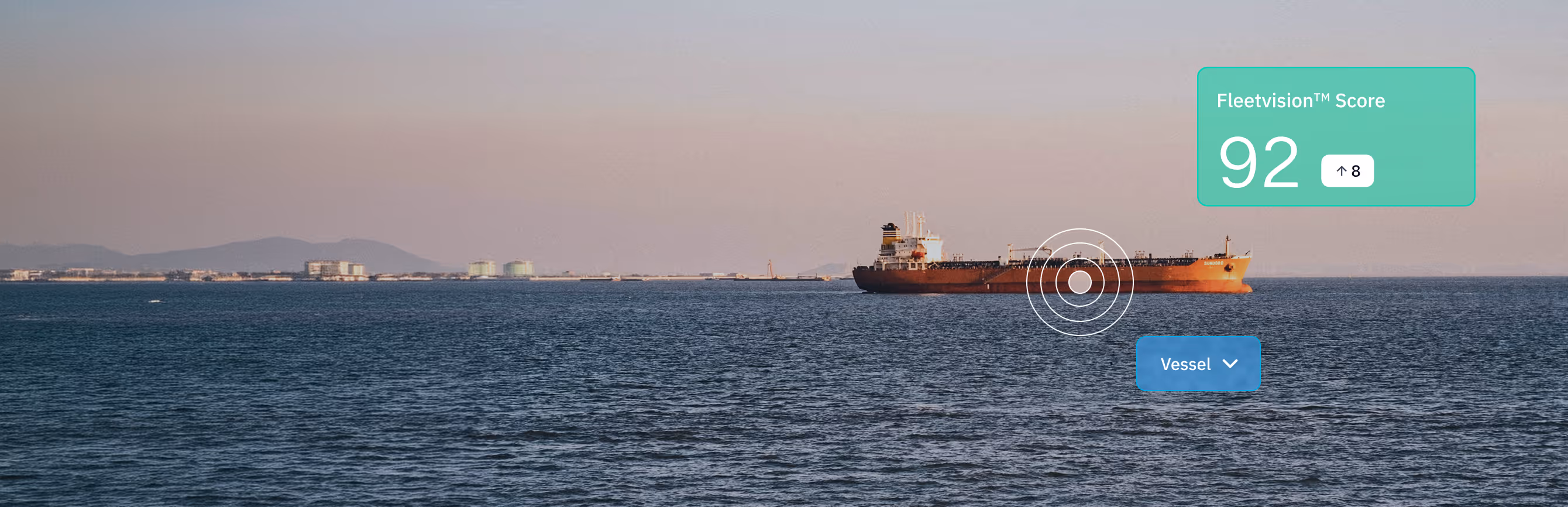 Cargo ship sailing on calm ocean waters with a distant coastline under a pastel sky, showing a Fleetvision score of 92.