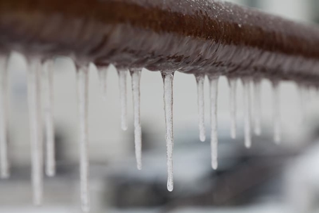frozen pipes with ice forming on it