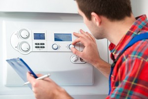 person adjusting thermostat