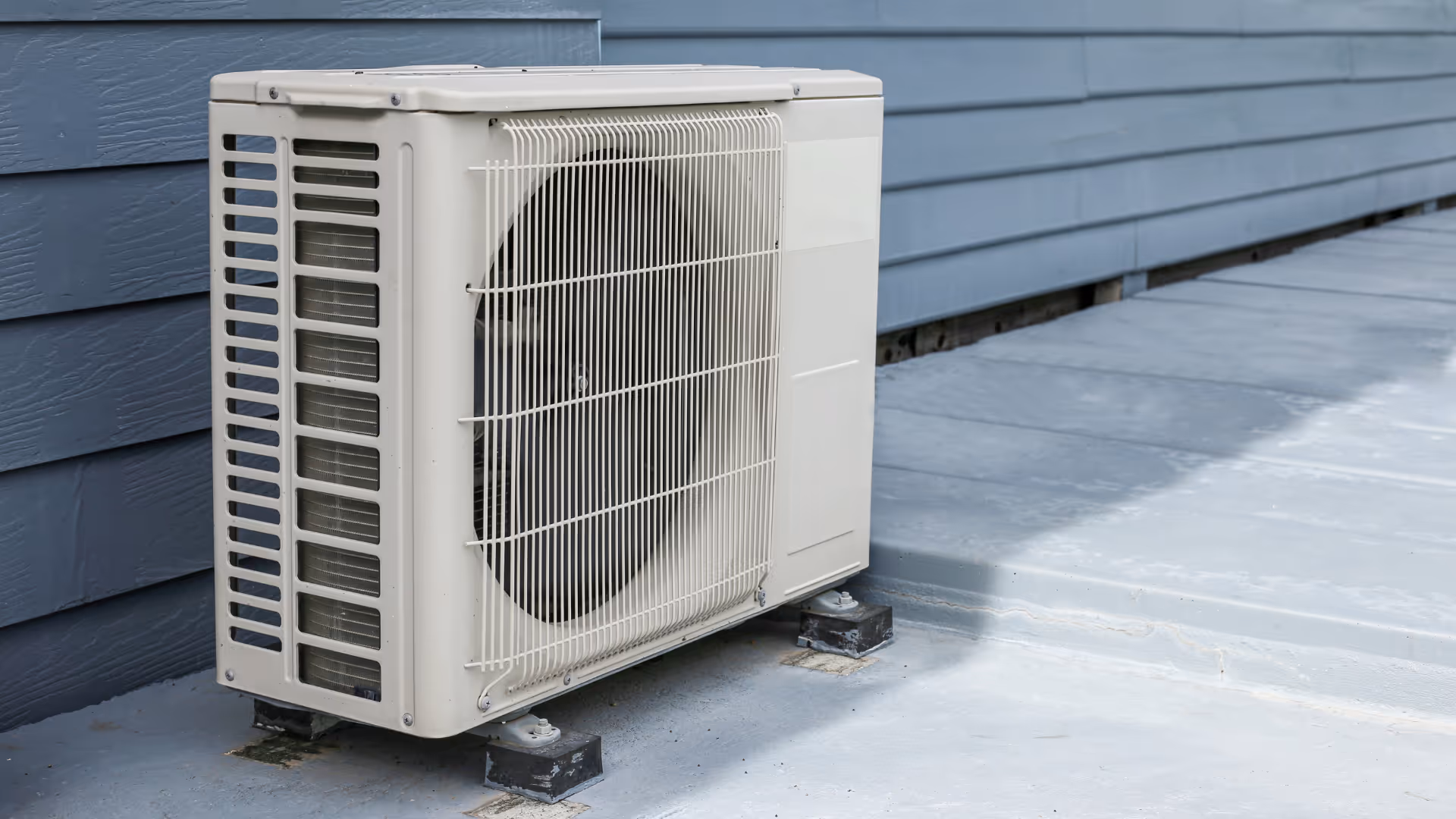 Outdoor air conditioning condenser units beside a home