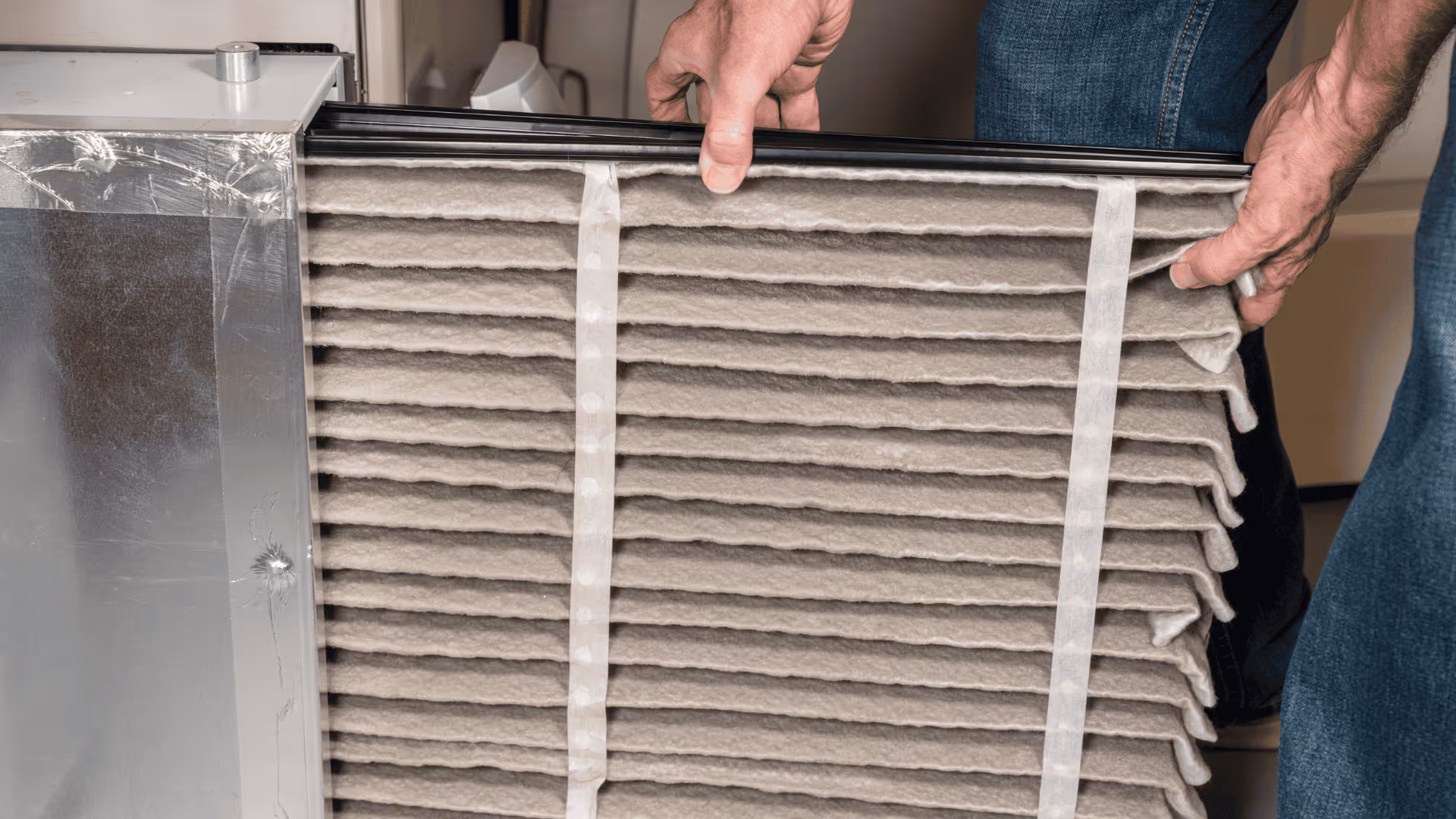 Technician cleaning and servicing a home furnace
