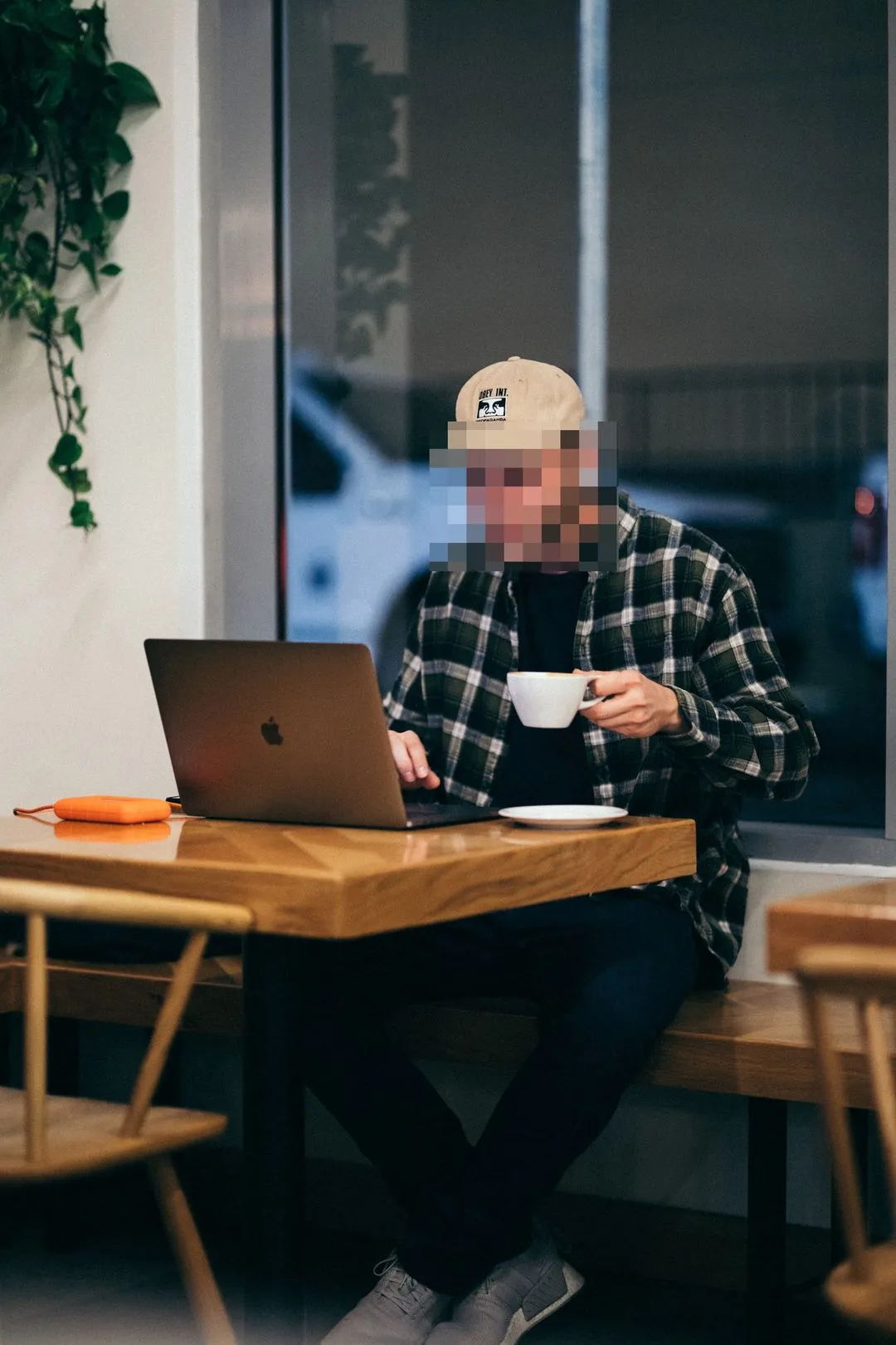 A person sitting at a table with a laptop.