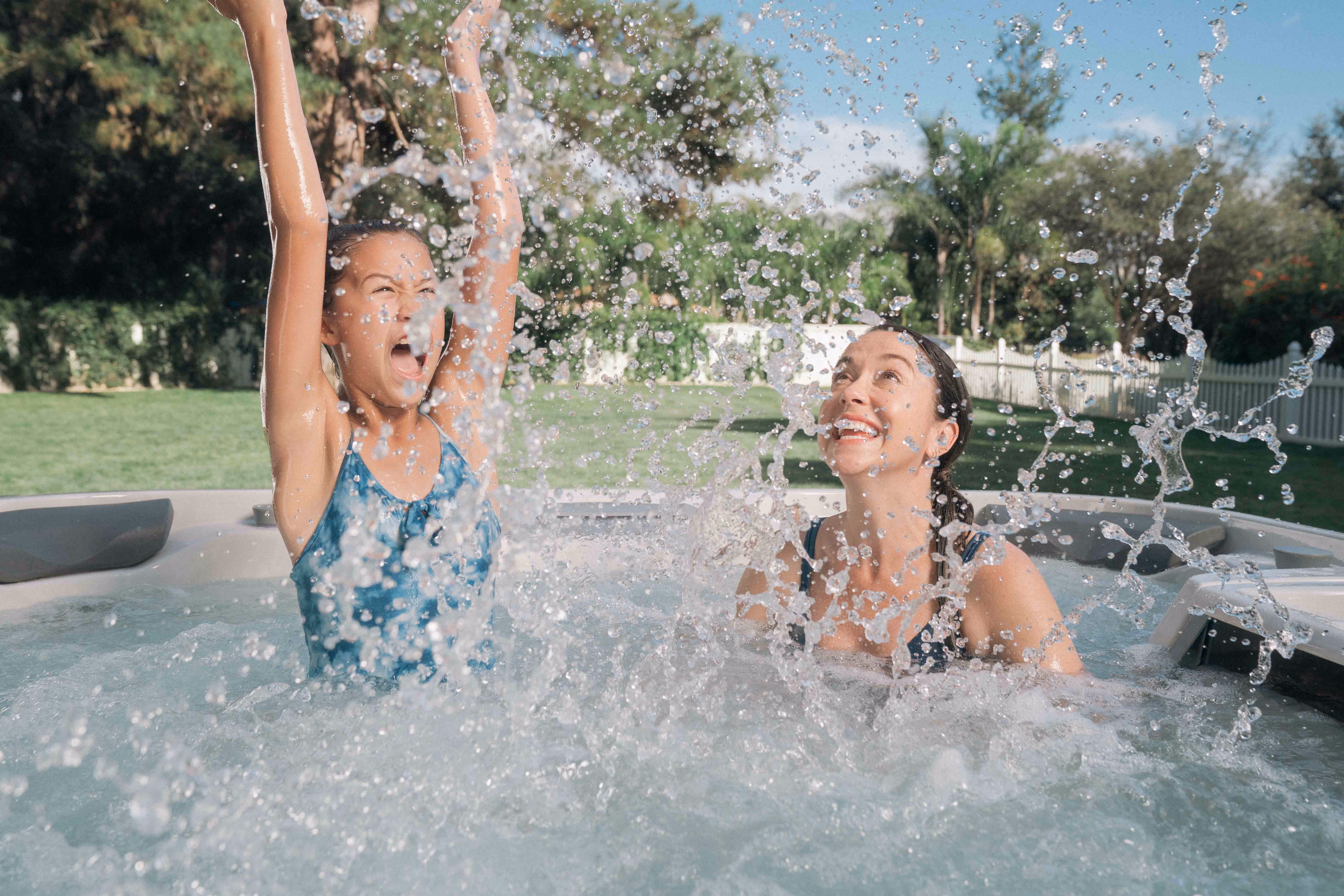 Family in backyard hot tub