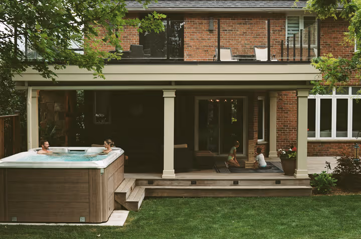 large backyard with couple in swim spa