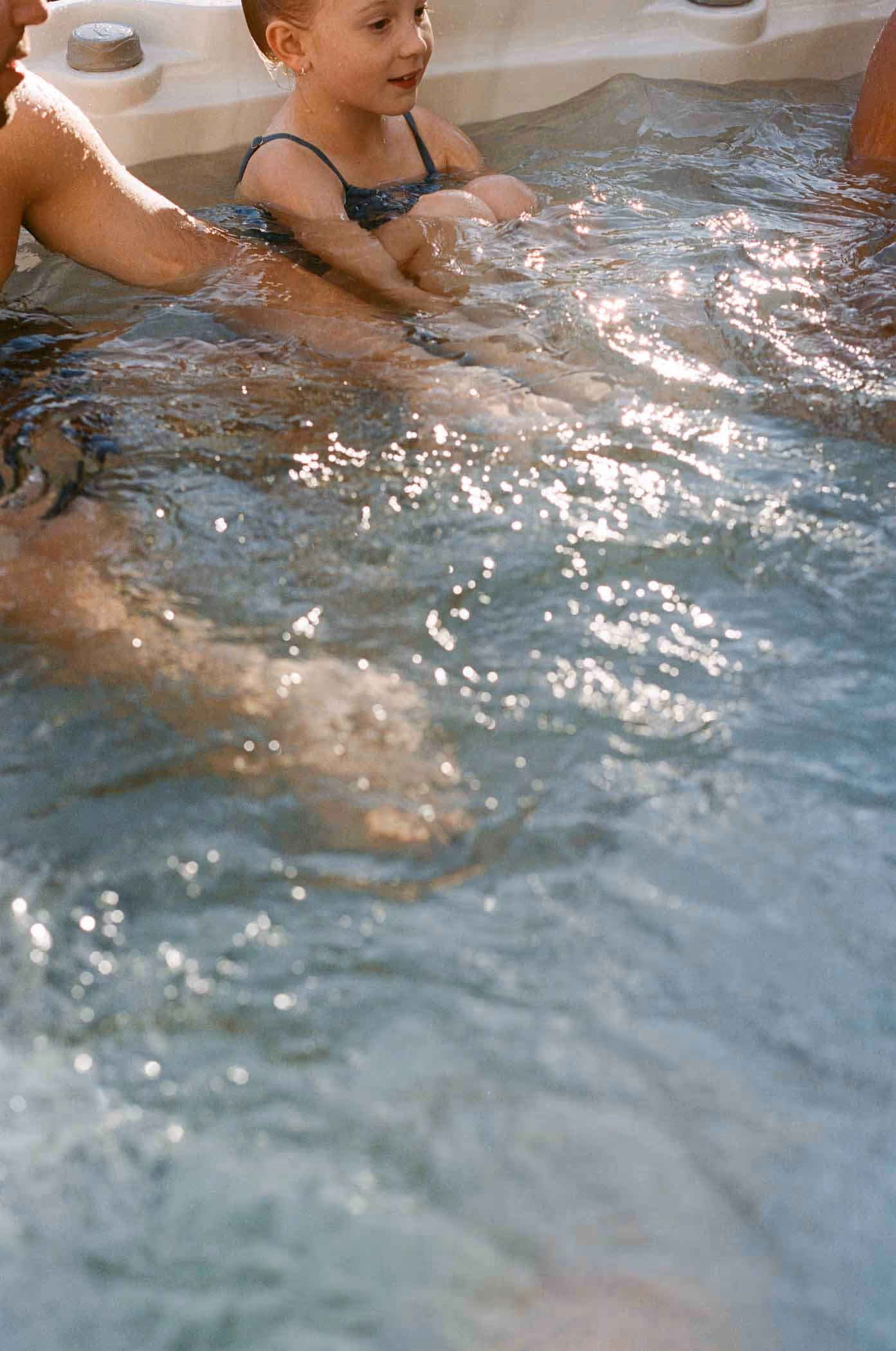 Family soaking in hot tub