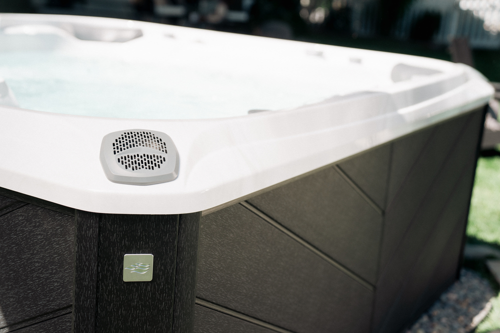 Close-up of a Sundance Spa hot tub with a modern exterior finish