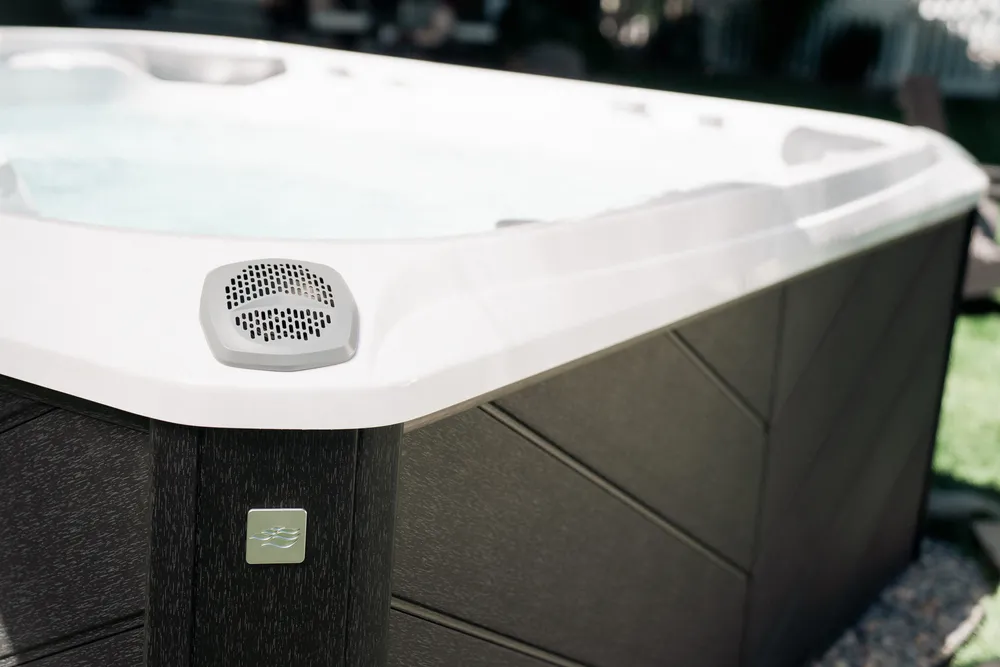 Close-up of a Sundance Spa hot tub with a modern exterior finish