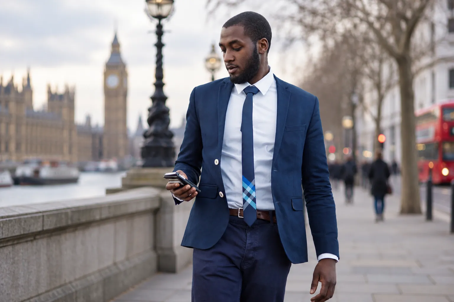 Businessman checking his phone while walking near Westminster in London