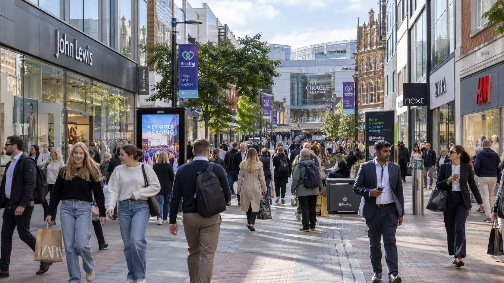Busy pedestrian shopping street in Reading town centre with digital advertising screens