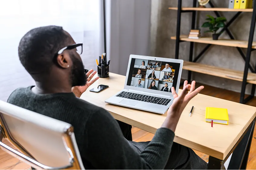 Man on a video call with colleagues while working from home