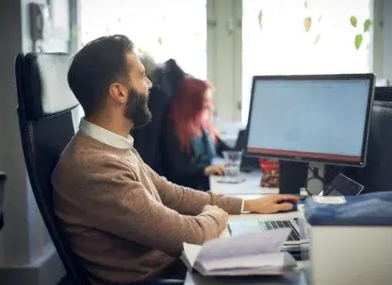 young man sitting at his desk in the office