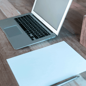 laptop and a paper on a desk