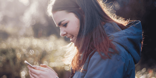 girl typing on phone