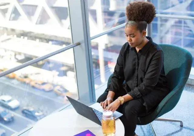 woman typing on laptop in office