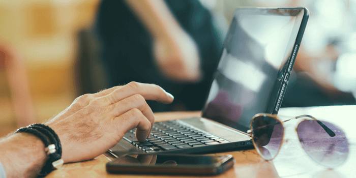 hand typing on laptop