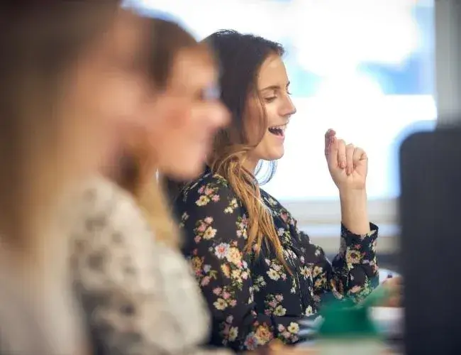 woman working in office and laughing