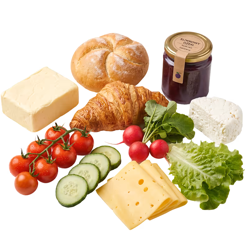 Świeże śniadanie z croissantem, bułką, serem, warzywami i przetworami.