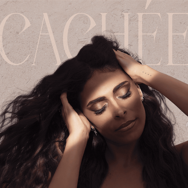 Woman with long dark hair and closed eyes holding her head, sunlight casting shadows on her face against a textured wall background with large text.