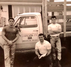 Three men posing in front of a truck with Landscaping Etc. sign on the door.