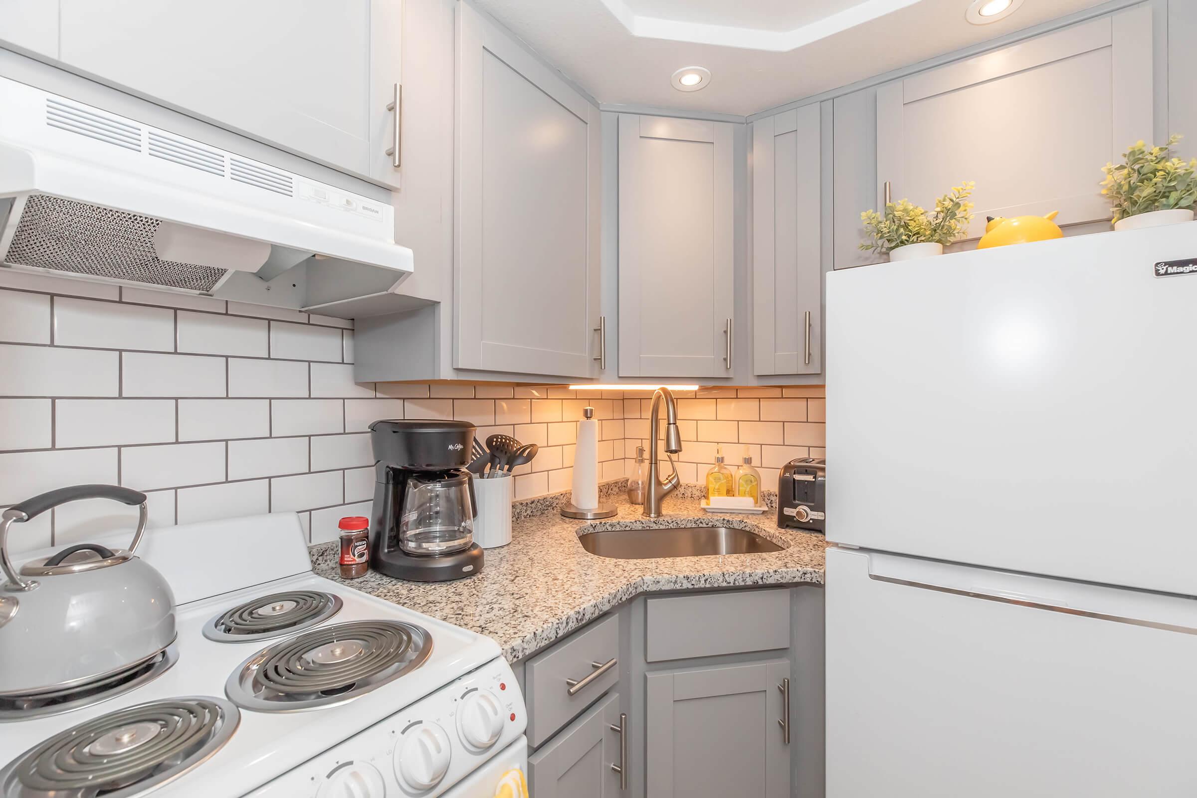 Studio kitchen with light grey cabinets 