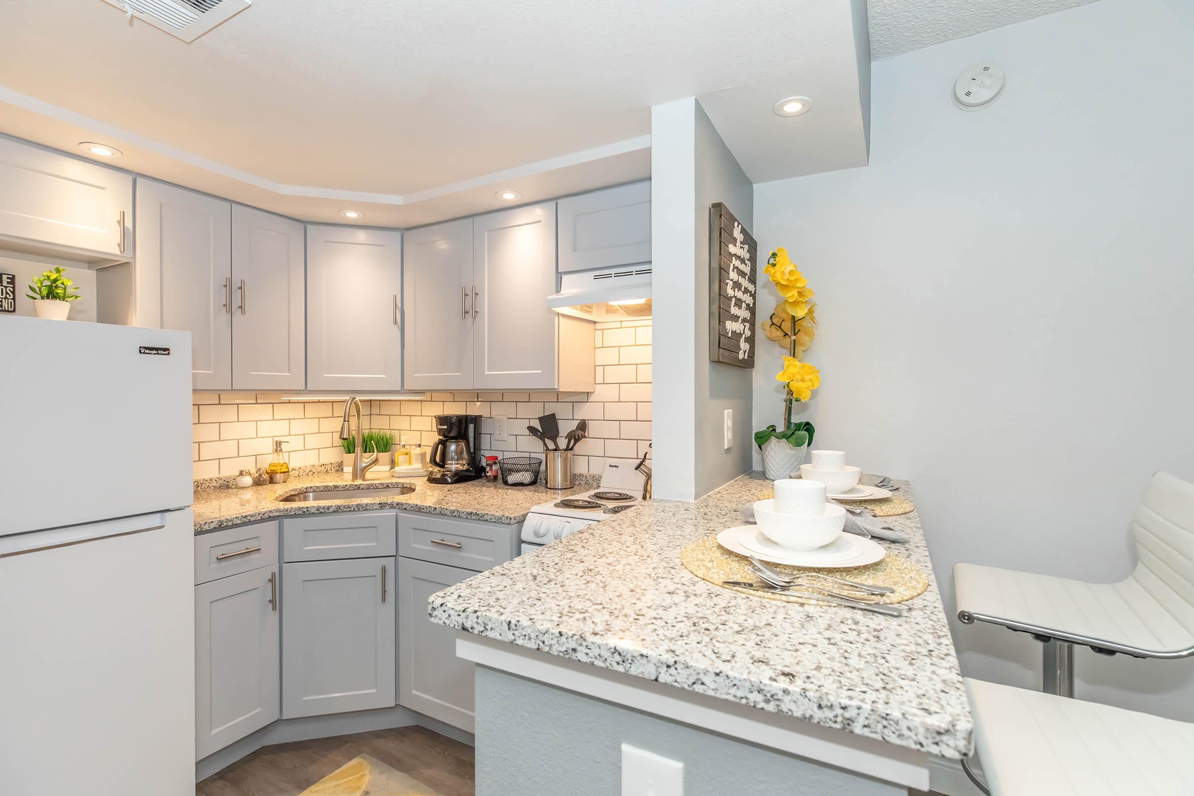 One bedroom kitchen with light grey cabinets