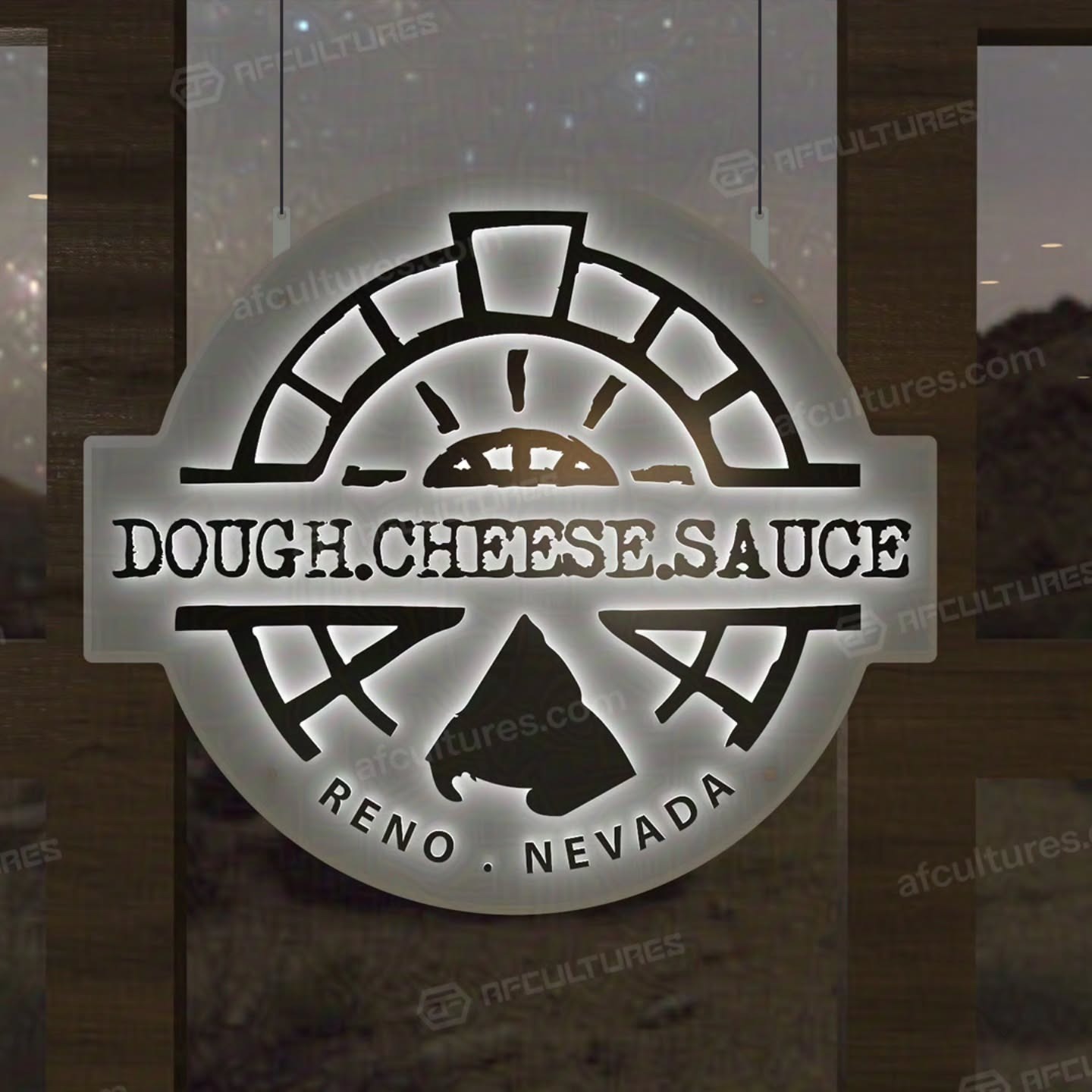 Backlit restaurant sign with text Dough. Cheese. Sauce and Reno Nevada, featuring stylized pizza oven and slice graphics.