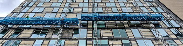An image of scaffolding on the side of a large commercial building
