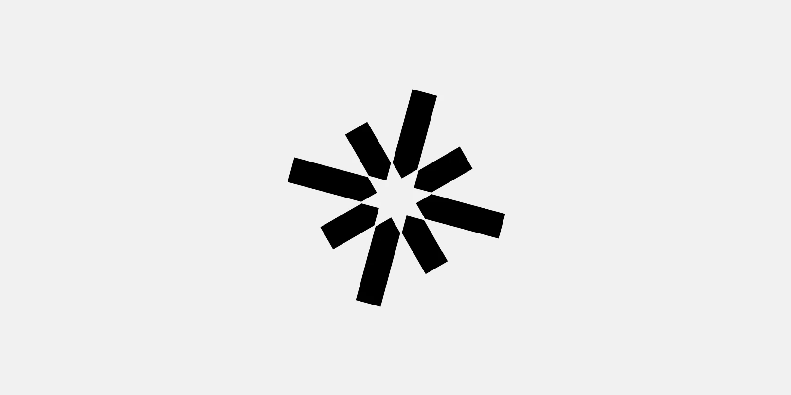 Abstract black starburst shape with eight irregular rectangular arms radiating from the center on a light gray background.