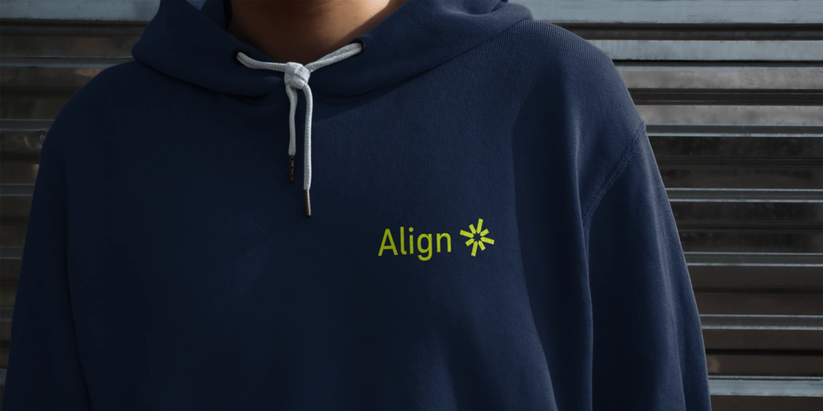 Person wearing a navy blue hoodie with the word 'Align' and a yellow asterisk-like logo on the chest.