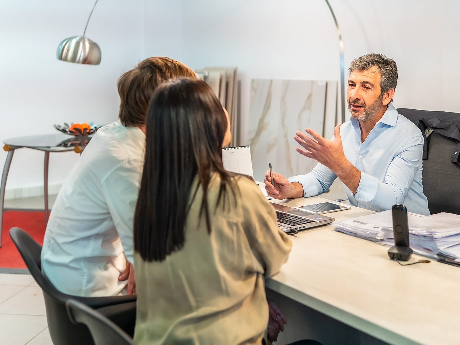 Two customers consult with a sales representative