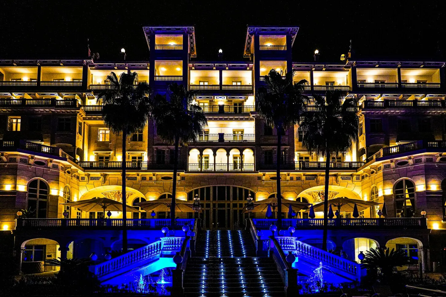 Large hotel property illuminated at night — illustrating the sleeping accommodation fire risk that distinguishes hotels from daytime commercial premises