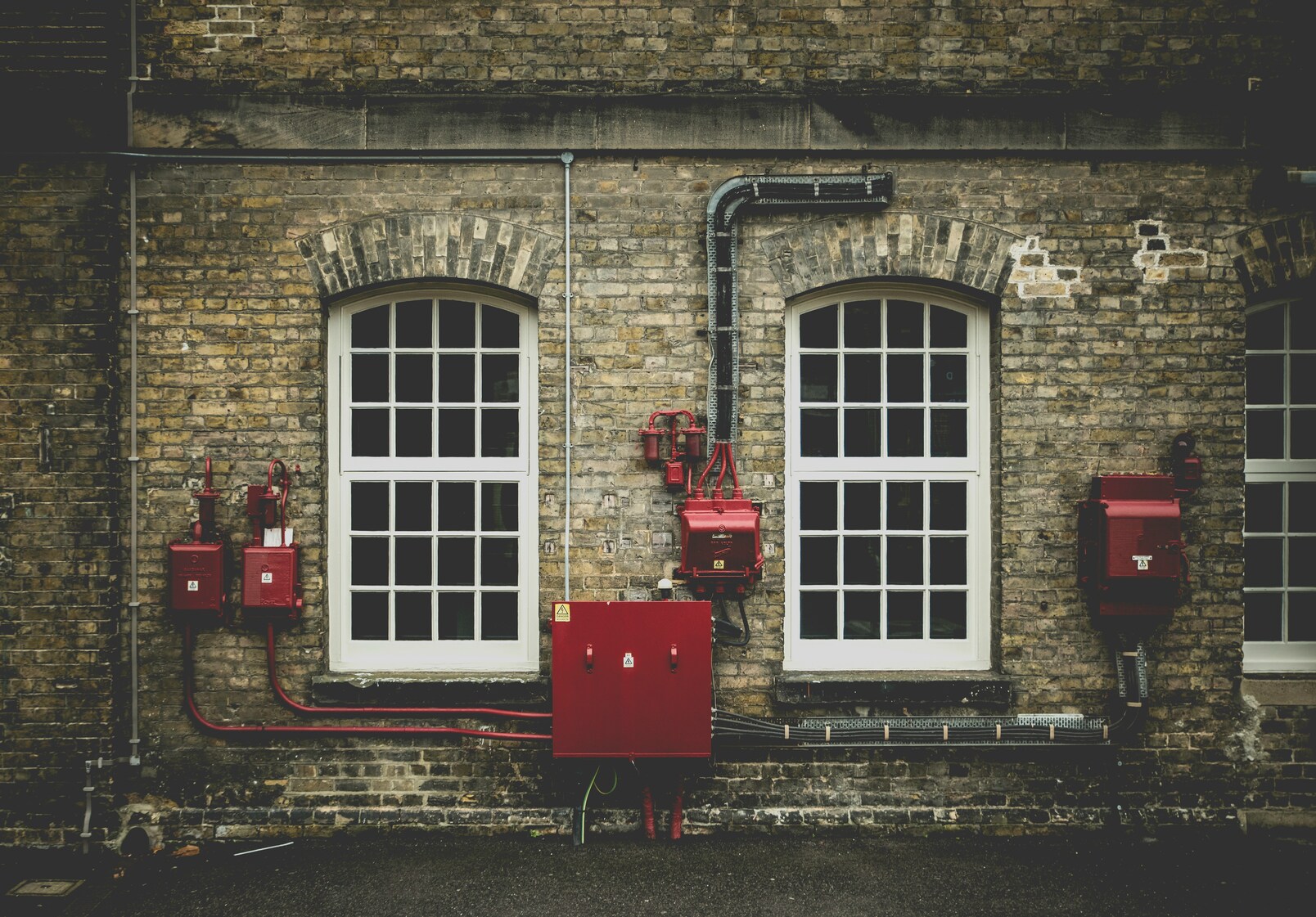 External fire alarm panels on a building — gaps identified in a hotel fire risk assessment